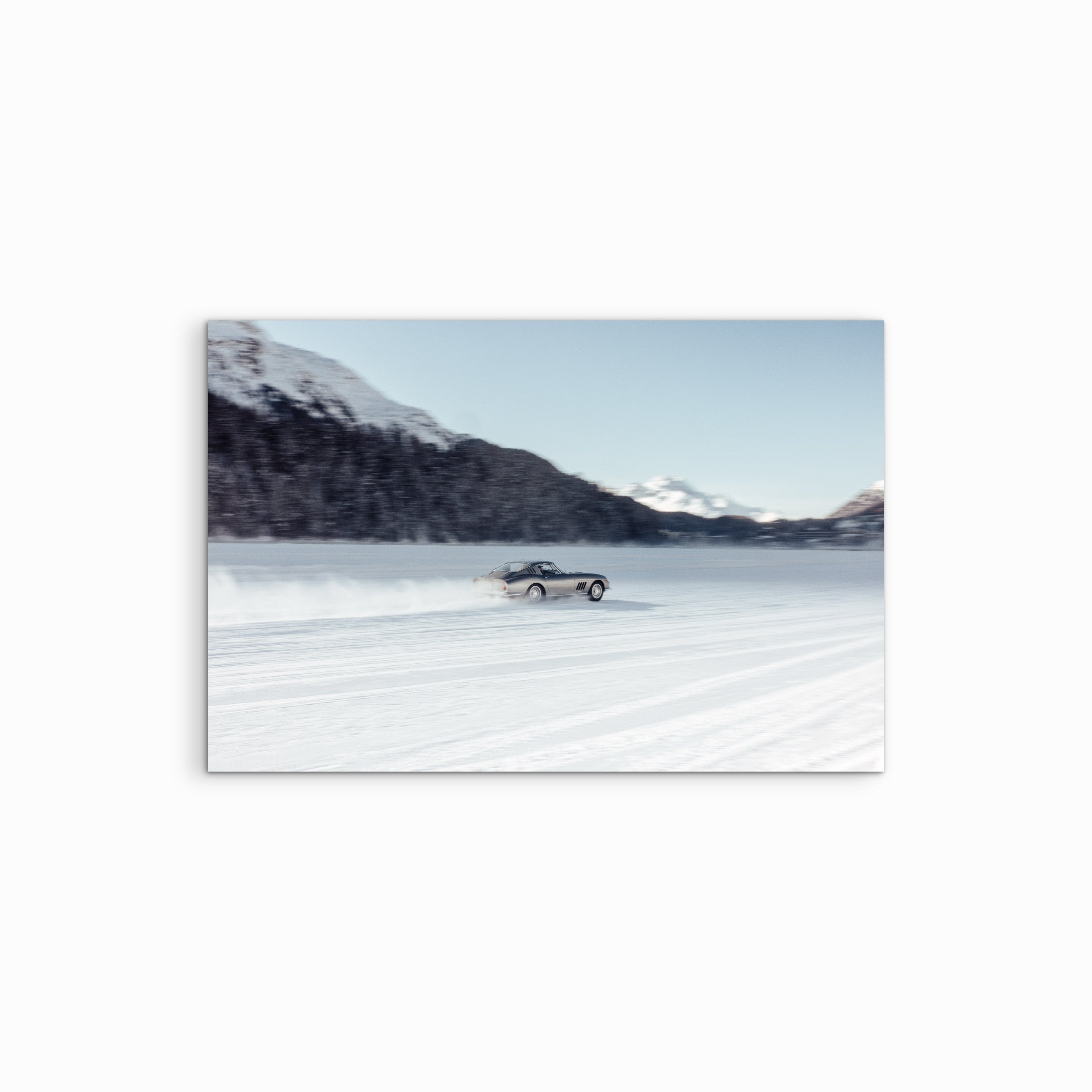 In this high-speed frame from The I.C.E. St. Moritz 2026, a sleek silver Ferrari 275 GTB/4 is captured mid-drift across the frozen surface of the lake. The 275 GTB/4 famously won the Icons on Wheels trophy in 2025, it remained a cornerstone of the 2026 display, showcasing why it is considered the absolute pinnacle of 1960s Italian grand touring. The image captures a rare moment where mid-century engineering meets the harsh, beautiful reality of an alpine winter.